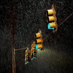 four traffic lights under the rain