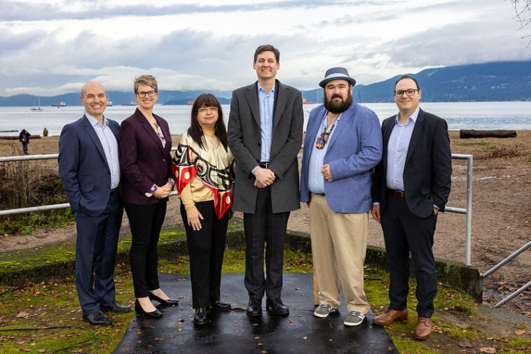 Nathan Cullen, Minister of Water, Land and Resource Stewardship; Jennifer Rice, Parliamentary Secretary for Rural Health; K̓áwáziɫ Marilyn Slett, Chief Councillor of the Heiltsuk Nation and President of Coastal First Nations; Premier David Eby; Dallas Smith, President of Nanwakolas Council; and Eddy Adra, CEO of Coast Funds at the funding announcement in Vancouver.