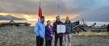 Gary Anandasangaree, Judi Thomas, Jeff Jones, and Dave Tovell, sign an agreement to return the use of ?A:?b?e:?s | Middle Beach to Pacheedaht First Nation near Port Renfrew, BC.