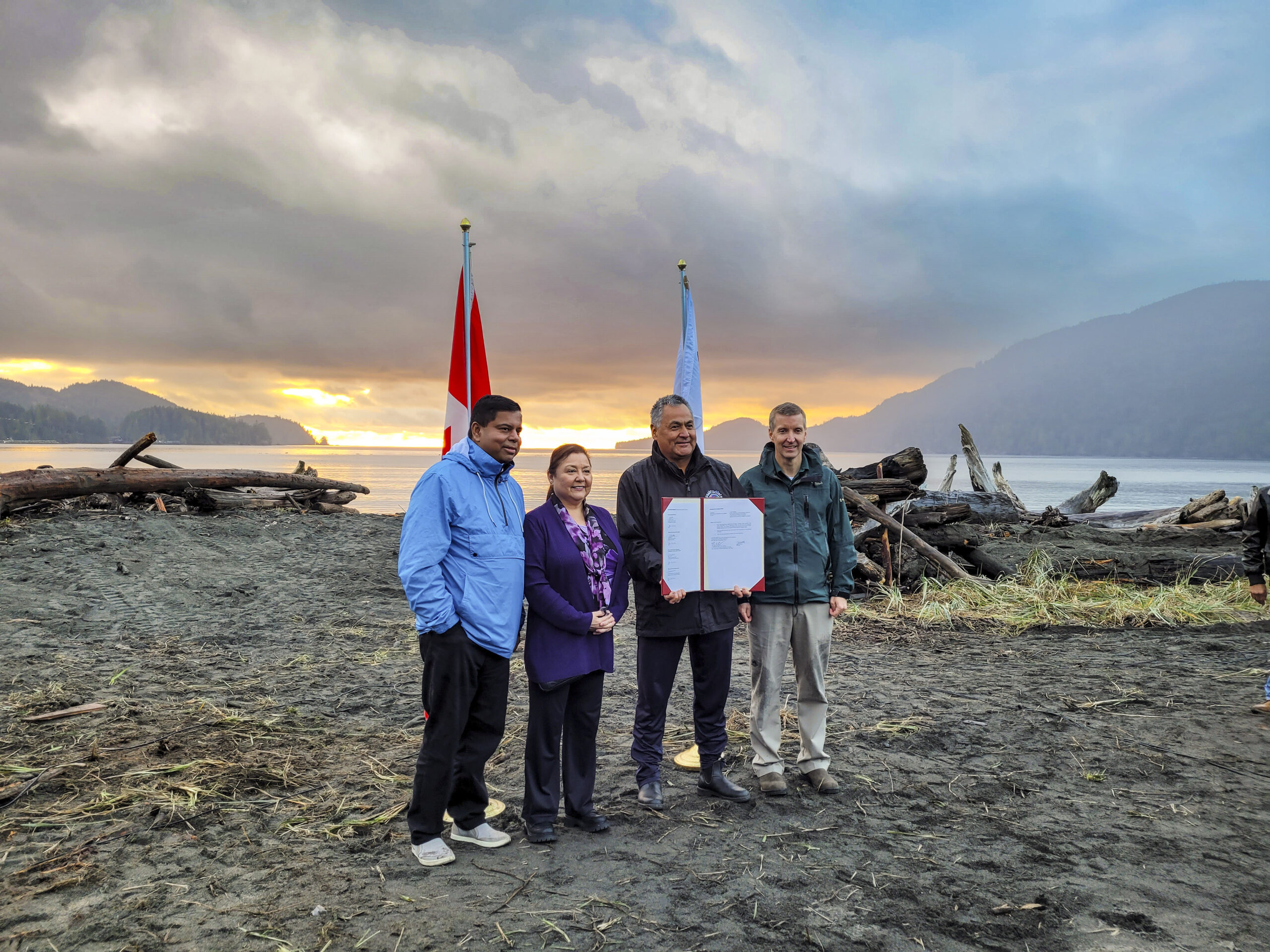 Gary Anandasangaree, Judi Thomas, Jeff Jones, and Dave Tovell, sign an agreement to return the use of ?A:?b?e:?s | Middle Beach to Pacheedaht First Nation near Port Renfrew, BC.