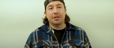 Jarred Sparrow in a plaid shirt and a cap.