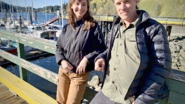 Morelia Trznadel and Patrick Keeling leaning against a railing