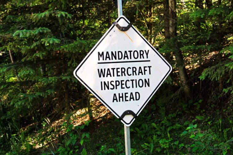 A sign that reads "mandatory watercraft inspection ahead"