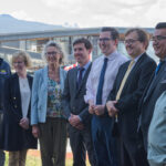 Representatives from the BC government and Federal government with BC-based spokespersons pose for a photo at the government's announcement of BC's fish farm transition transition plan.