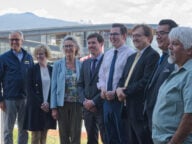 Representatives from the BC government and Federal government with BC-based spokespersons pose for a photo at the government's announcement of BC's fish farm transition transition plan.