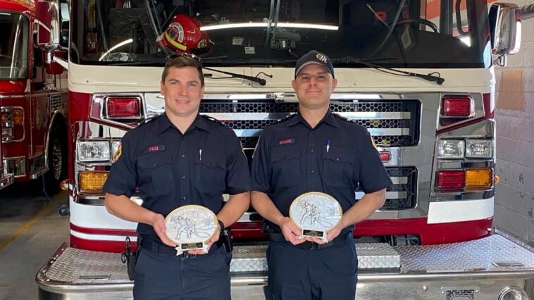 Ryan Fuzi Prince Rupert Fire Fighter of the Year (left), and Dylan Sidoni, Fire Officer of the Year, pose with their plaques at the Prince Rupert Fire Hall. Prince Rupert Fire Rescue