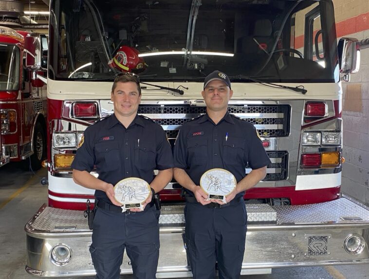 Ryan Fuzi Prince Rupert Fire Fighter of the Year (left), and Dylan Sidoni, Fire Officer of the Year, pose with their plaques at the Prince Rupert Fire Hall. Prince Rupert Fire Rescue