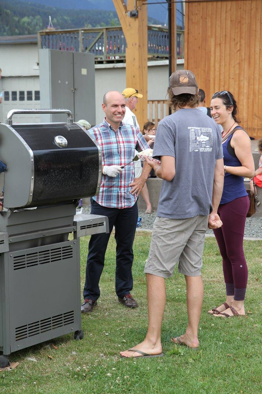 Nathan Cullen participates in a community barbecue