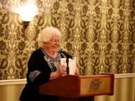 Linda Lutz stands at a podium at an event awarding grants to community organizations in Prince Rupert BC