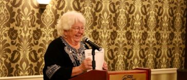 Linda Lutz stands at a podium at an event awarding grants to community organizations in Prince Rupert BC