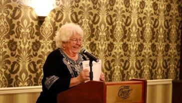 Linda Lutz stands at a podium at an event awarding grants to community organizations in Prince Rupert BC