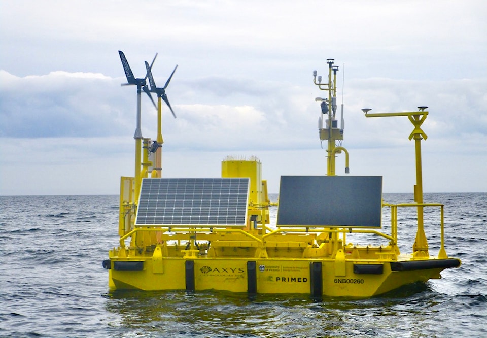 A yellow aluminum buoy with wind and solar measuring instruments floats off the coast of Haida Gwaii