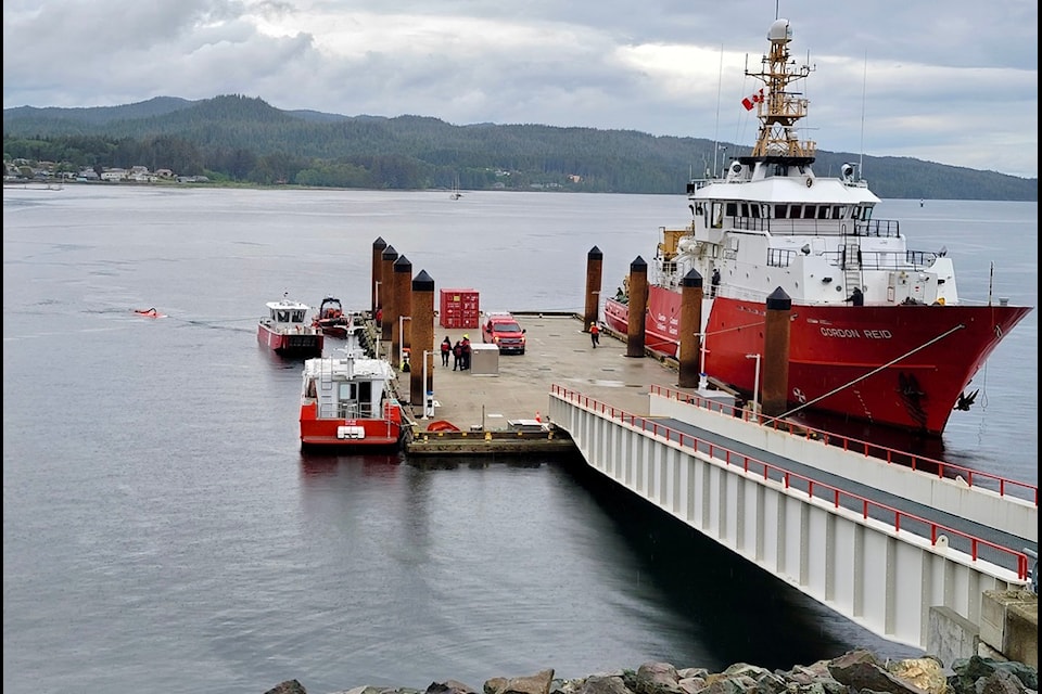 A red Canadian Coast Guard vessel reloading at a dock