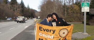 Kimberly (left) and Jordan Joseph on Highway 99, Sḵwx̱wú7mesh (Squamish). The couple planned a walk from “Prince Rupert” to “Victoria” raising awareness for indigenous children in foster care