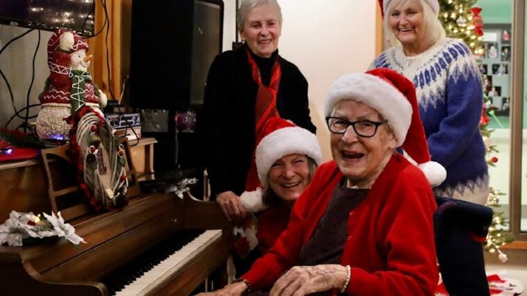 Charlotte Rowse played Christmas jingles on her piano while the crowd sang along during her annual women's sherry party on Dec. 6 at Acropolis Manor.