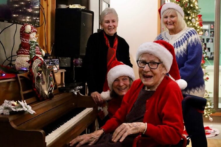 Charlotte Rowse played Christmas jingles on her piano while the crowd sang along during her annual women's sherry party on Dec. 6 at Acropolis Manor.